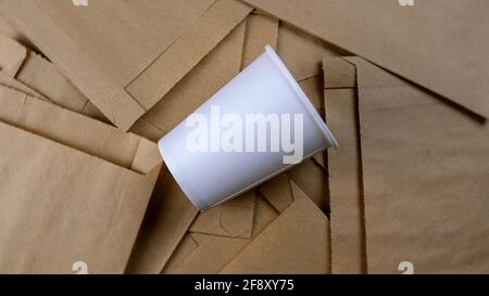 Empty paper package, eco-friendly disposable biodegradable packaging for goods, and empty paper cup. Selective focus. Eco friendly background. Top vie Stock Photo