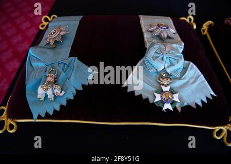 The Order of the Elephant (Denmark), and the Order of the Redeemer (Greece) sewn onto a cushion in St James's Palace, London. The cushions displaying medals and decorations conferred on the Duke of Edinburgh by the United Kingdom and other countries across the world, together with his Field Marshal's baton and Royal Air Force Wings, will be placed on the altar in St George's Chapel, in Windsor, ahead of his funeral on Saturday. Picture date: Tuesday April 13, 2021. Stock Photo