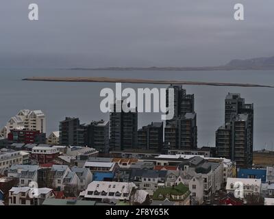 Aerial view over the west of Reykjavik downtown with residential buildings, including a black colored high-rise apartment building on the coast. Stock Photo