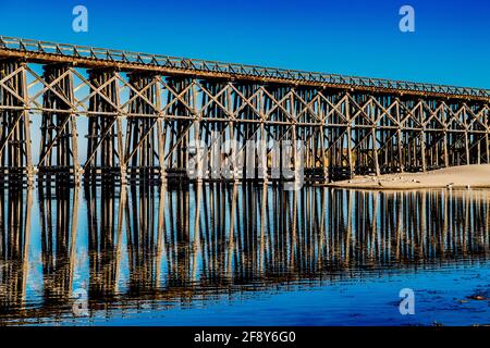 Bridge reflected in lake, Pudding Creek Trestle, Fort Bragg, California, USA Stock Photo