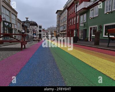View of empty rainbow road, a shopping street in the center of Reykjavik, dedicated to Reykjavik Pride Gay Festival on cloudy winter day.