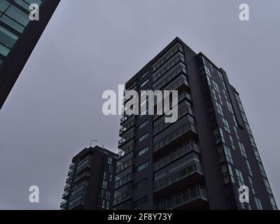 Low angle view of residential high-rise buildings with expensive luxury apartments and black colored facade in the center of Reykjavik in winter. Stock Photo