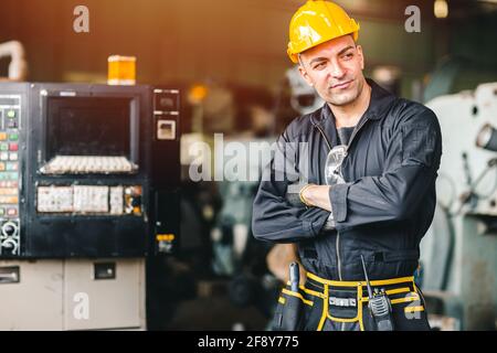 Confidence Smart engineer worker, portrait handsome with safety suit with factory heavy industry machine. Stock Photo