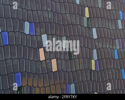 Closeup view of the patterned glass facade of concert hall and conference center Harpa in Reykjavik downtown inspired by Icelandic basalt landscape. Stock Photo