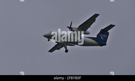 Low angle view of Air Iceland Connect plane (De Havilland DHC-8-200), part of Icelandair Group, approaching Reykjavik domestic airport (RKV) in winter. Stock Photo
