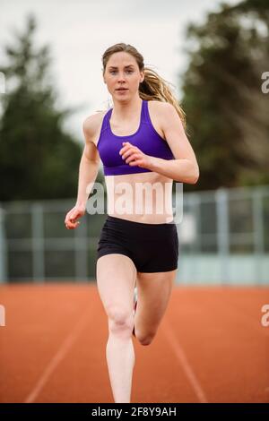 woman running on a running track Stock Photo - Alamy