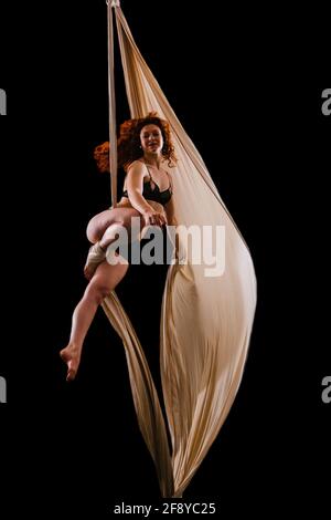 Woman dancing with grace as aerialist Stock Photo