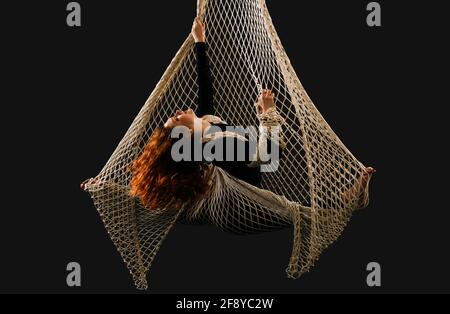 Woman dancing with grace as aerialist Stock Photo