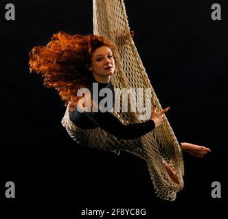 Woman dancing with grace as aerialist Stock Photo