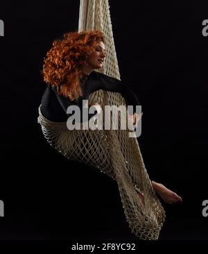 Woman dancing with grace as aerialist Stock Photo