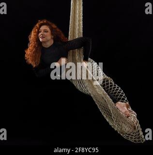 Woman dancing with grace as aerialist Stock Photo