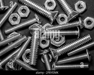 Black and white photograph with close-up of metal nuts and bolts Stock Photo