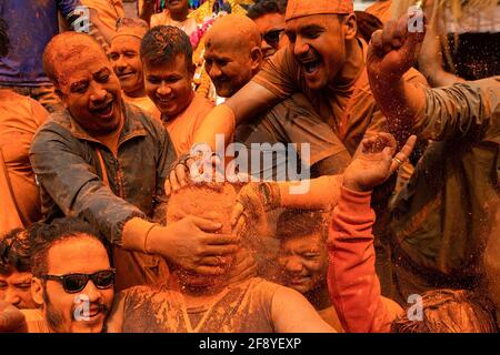 Bhaktapur, Nepal. 15th Apr, 2021. Devotees play with vermilion powder while celebrating Sindoor Jatra vermillion powder festival. Revelers carried chariots of the Hindu gods and goddesses and hurled vermillion powder onto each other as part of the celebrations commencing Nepalese New Year. Credit: SOPA Images Limited/Alamy Live News Stock Photo