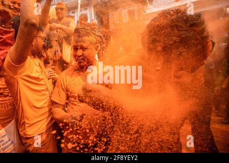 Bhaktapur, Nepal. 15th Apr, 2021. Devotees covered in vermilion powder celebrate 'Sindoor Jatra' vermillion powder festival. Revelers carried chariots of the Hindu gods and goddesses and hurled vermillion powder onto each other as part of the celebrations commencing Nepalese New Year. Credit: SOPA Images Limited/Alamy Live News Stock Photo
