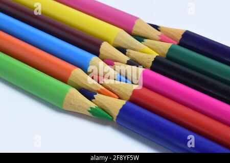 colored pencils arranged head to head isolated on a white background. wooden pencils background Stock Photo