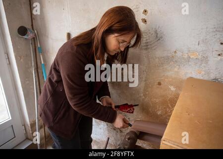 Spanish woman sanding a fan working at a hand fan design workshop Stock Photo