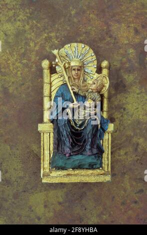 Model of Virgin Mary sitting on gold throne with sceptre and baby Jesus on her lap Stock Photo