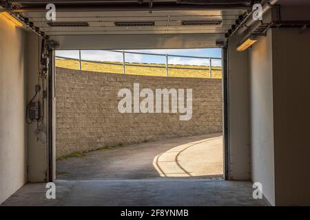 Close up view of exit from underground garage with automatic gates. Sweden. Stock Photo