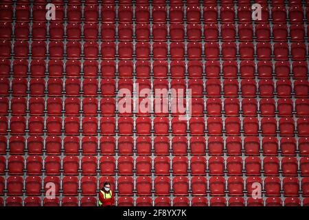 A ball girl sits alone in the stands during the Sky Bet Championship match at the AESSEAL New York Stadium, Rotherham. Picture date: Thursday April 15, 2021. Stock Photo