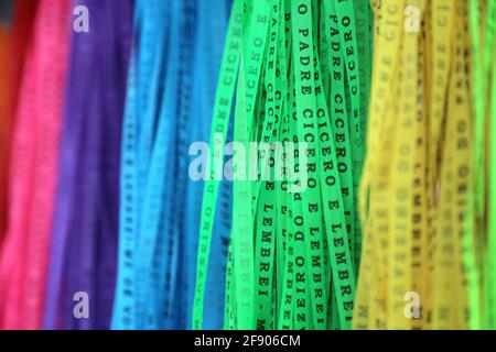 Several religious ribbons, together and hanging side by side in seven different colors, only the light green highlighted. Stock Photo