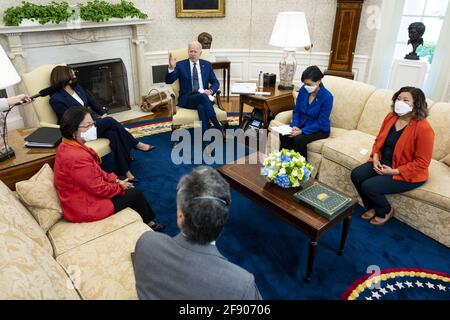 U.S. President Joe Biden, center, speaks as U.S. Vice President Kamala Harris, left, listens during a meeting with the Congressional Asian Pacific American Caucus Executive Committee including Representative Mark Takano, a Democrat from California, from bottom left, Senator Mazie Hirono, a Democrat from Hawaii, Representative Judy Chu, a Democrat from California, and Representative Grace Meng, a Democrat from New York, in the Oval Office of the White House in Washington, DC, U.S., on Thursday, April 15, 2021. The Biden administration imposed a raft of new sanctions on Russia, including long- Stock Photo