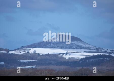 Roseberry Topping with a light covering of snow in April, North Yorkshire; England; United Kingdom Stock Photo