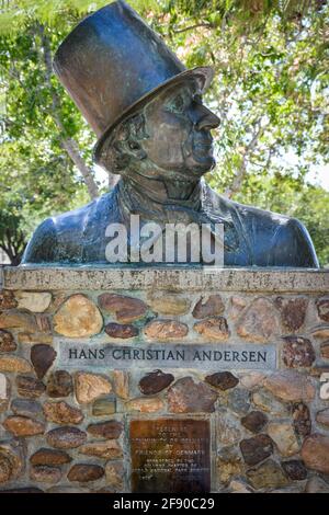 A sculptural bust of Hans Christen Andersen wearing a top hat at a namesake Park with dedication plaque in the Danish Village of Solvang, CA Stock Photo