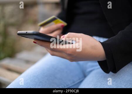 Woman use smartphone for ecommerce shopping credit card payment on a smartphone,hi tech business Stock Photo