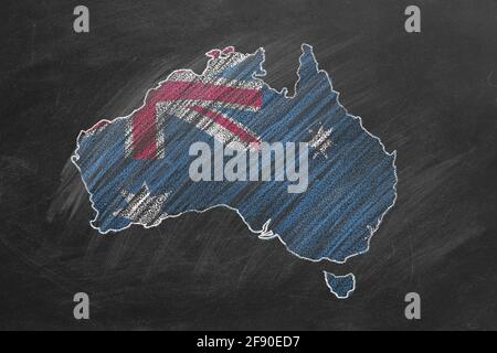 Country map and flag of Australia drawing with chalk on a blackboard. One of a large series of maps and flags of different countries. Education, trave Stock Photo