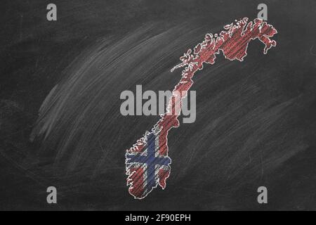 Country map and flag of Norway drawing with chalk on a blackboard. One of a large series of maps and flags of different countries. Education, travel, Stock Photo