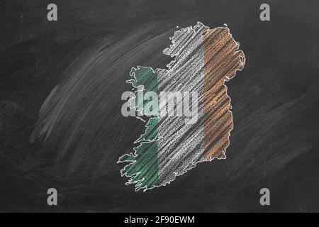 Country map and flag of Ireland drawing with chalk on a blackboard. One of a large series of maps and flags of different countries. Education, travel, Stock Photo