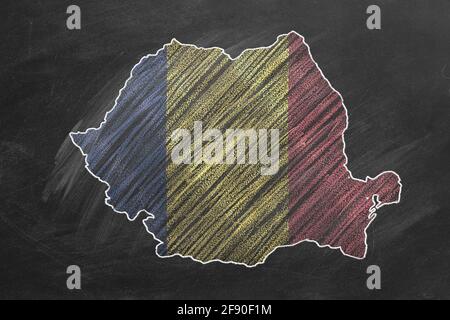 Country map and flag of Romania drawing with chalk on a blackboard. One of a large series of maps and flags of different countries. Education, travel, Stock Photo