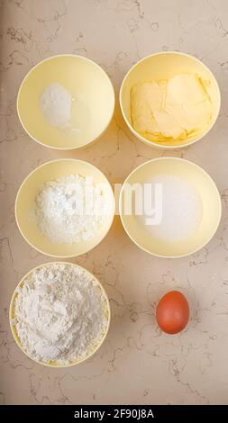 Products and ingredients in small round bowls to bake cookies flat lay Stock Photo