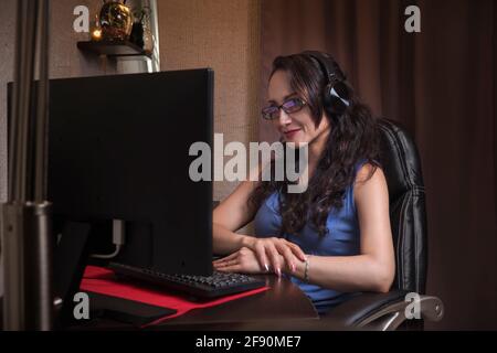 Pretty middle-aged Latina woman on video call in her work area Stock Photo