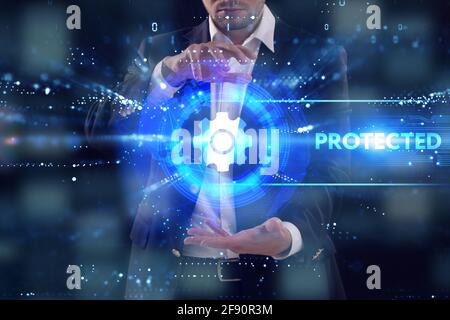 Business, Technology, Internet and network concept. Young businessman working on a virtual screen of the future and sees the inscription: Protected Stock Photo