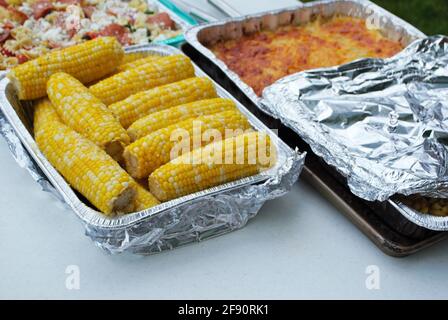 large assortment of dishes on the food table at a picnic Stock Photo