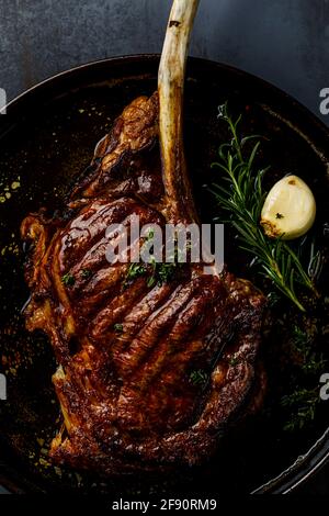 Barbecue grilled Tomahawk Steak dark background close-up Stock Photo