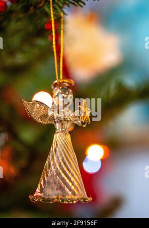 glass angel ornament hanging on a Christmas tree Stock Photo