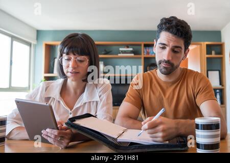 Young couple paying bills on digital tablet. Stock Photo