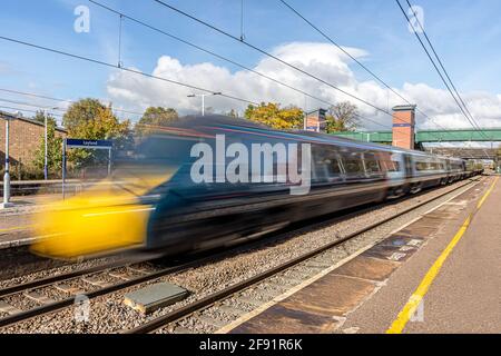 British Rail Class 390 Avanti West Coast train passing at high speed through Leyland railway station Stock Photo