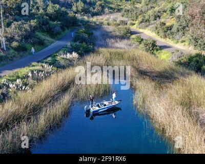 Aerial view of fishers and their fishing rods trying to catch fish on a small motor boat at the Miramar lake, San Diego, California. USA. March, 18th, 2020 Stock Photo