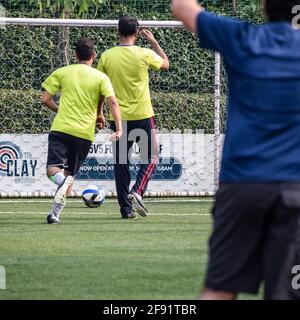 New Delhi, India - July 19 2019: Footballers of local football team during game in regional Derby championship on a bad football pitch. Hot moment of Stock Photo