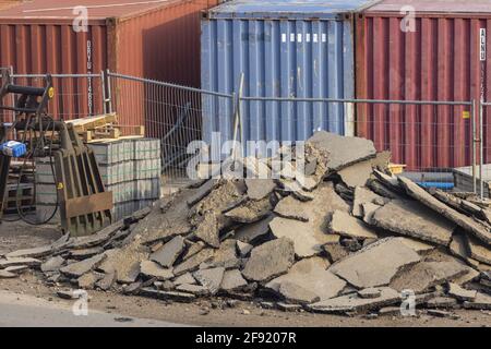 ZUTPHEN, NETHERLANDS - Mar 24, 2021: Heap of broken up pieces of temporary road during construction for reuse Stock Photo