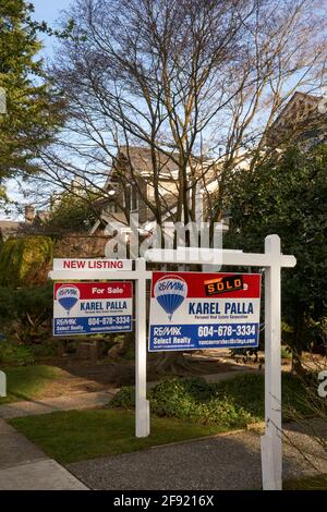 Real estate for sale and sold signs outside houses in Vancouver, British Columbia, Canada Stock Photo