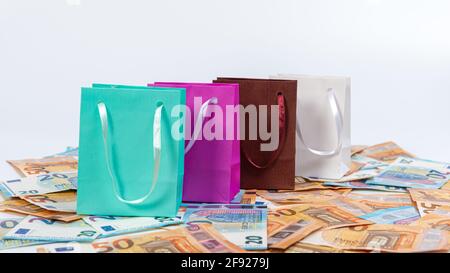 close-up of colorful shopping bags on euro banknotes, commerce and sale concept Stock Photo