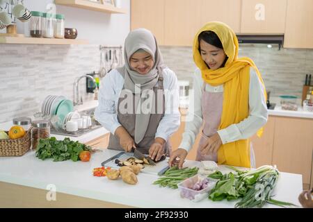 muslim woman enjoy cooking dinner together for iftar breaking the fast on ramadan Stock Photo