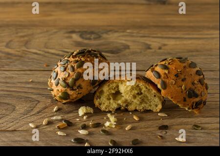 Homemade Gluten-free vegan pumpkin scones with seeds on wooden table. Stock Photo