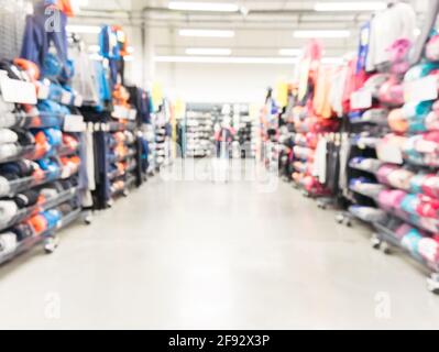 Abstract blurred sport and travel hypermarket aisle with colorful shelves as background Stock Photo