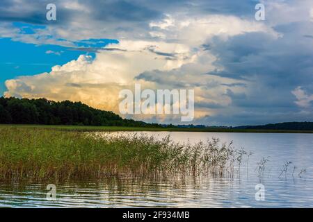 beautiful waterscape on a lake and dramatic gloomy and cloudy sky at evening. beauty in nature. horizontal photo