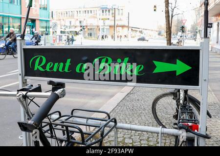 Berlin, Germany. 24th Mar, 2021. A sign with the inscription 'Rent a Bike' stands in front of the bike shop 'Du und ich'. In the shop in Prenzlauer Berg, in addition to buying new bikes, you can also have your old bike repaired and rent bikes. Credit: Gerald Matzka/dpa-Zentralbild/ZB/dpa/Alamy Live News Stock Photo